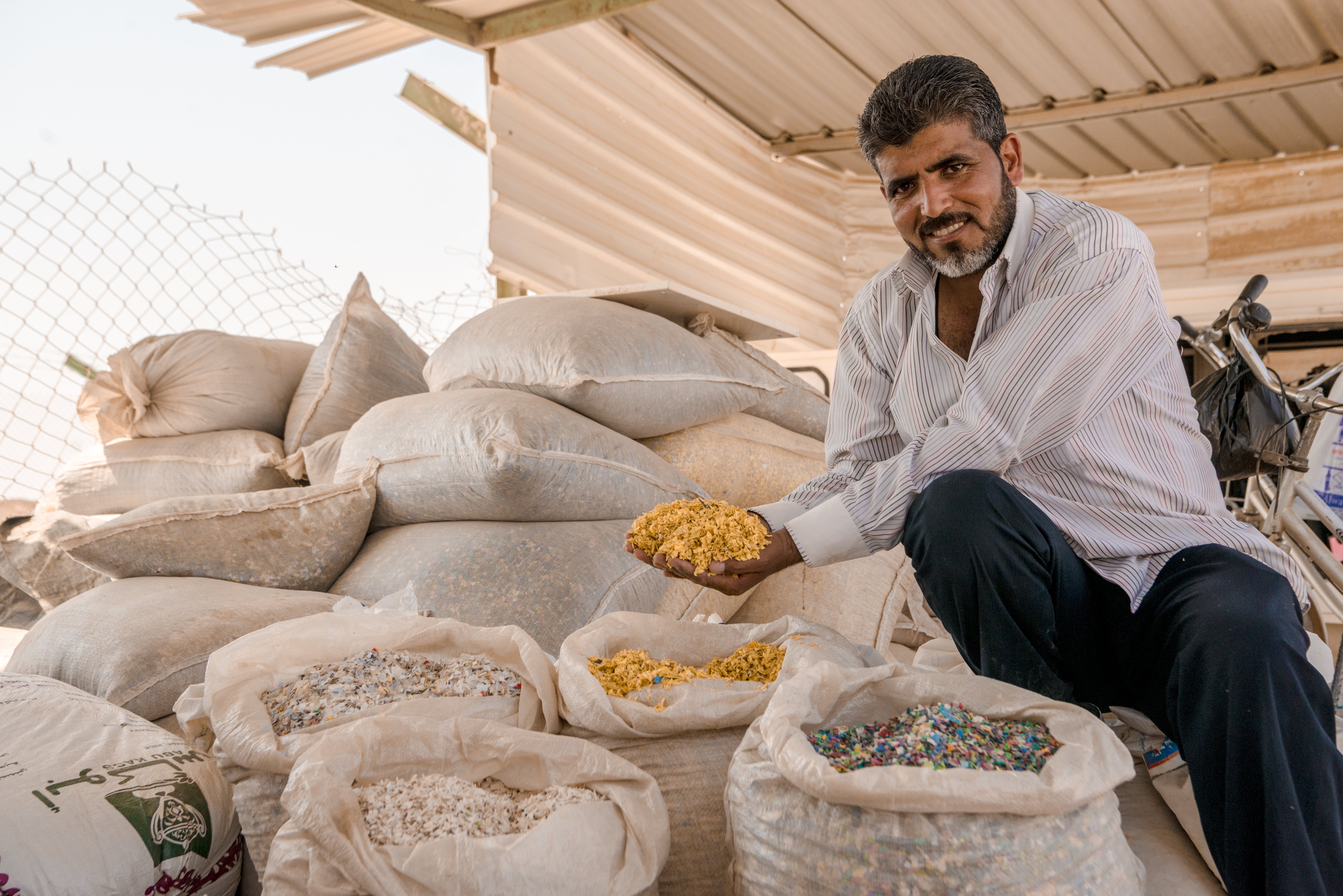 Once waste is separated at the Recycling Centre, it is put through a shredder and then gathered in big bags. The material is then picked up by Jordanian trucks that deliver them to recycling facilities outside the camp. One ton of plastic is sold for 200 Jordanian Dinars, while a ton of cardboard goes for 25 Jordanian Dinars. The Recycling Project Centre makes 1,200 Jordanian Dinars per month for all the materials in these big bags. (Photo: Poon Wai Nang/Oxfam)